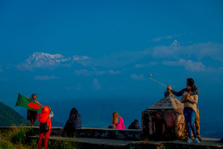 POKHARA, NEPAL, SEPTEMBER 04, 2017: Unidentified tourists at hilltop of the Sarangkot lookout point,...