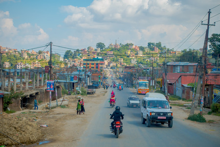 POKHARA, NEPAL OCTOBER 10, 2017: Outdoor view of asphalted road with some motorbikes, cars parked around in the street, in a gorgeous day, located in Pokhara, Nepalのeditorial素材