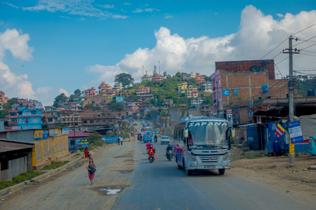POKHARA, NEPAL OCTOBER 10, 2017: Outdoor view of asphalted road with some motorbikes, cars parked around in the street, in a gorgeous day, located in Pokhara, Nepalのeditorial素材