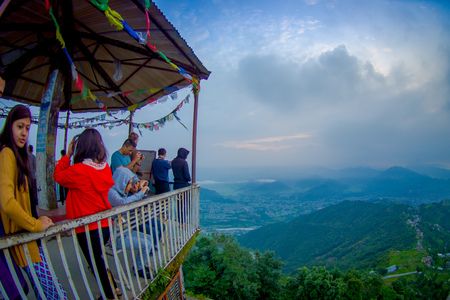 POKHARA, NEPAL, SEPTEMBER 04, 2017: Unidentified tourist under a hut at hilltop of the Sarangkot lookout point in the mountain to view Annapurna Range during sunrise at Sarangkot, Nepal, fish eye effectのeditorial素材