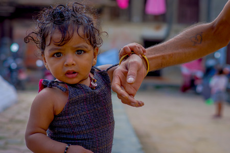 KATHMANDU, NEPAL OCTOBER 15, 2017: Portrait of beautiful little daugher at outside of Durbar Square, Kathmandu, Nepalのeditorial素材