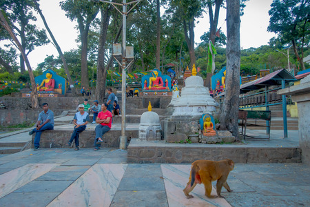 KATHMANDU, NEPAL OCTOBER 15, 2017: Unidentified people walking close to small stupas surrounded by prayer flags at Swayambhu Nath temple, Kathmandu, Nepalのeditorial素材