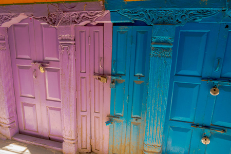 KATHMANDU, NEPAL OCTOBER 15, 2017: Outdoor view of wooden doors of two coors, blue and pink at outdoors in Durbar square in Kathmandu, Nepalのeditorial素材