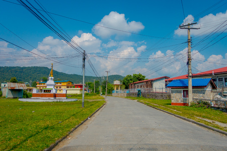 POKHARA, NEPAL - OCTOBER 06 2017: Outdoor view of different buildings with a pavement street, with some cables lines in Pokhara, Nepalのeditorial素材