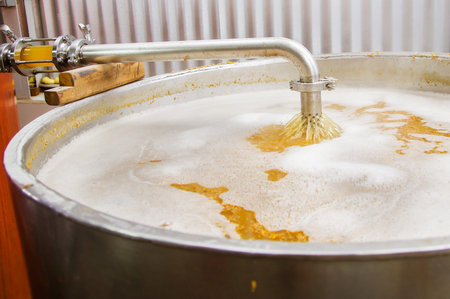 Modern beer plant brewery , with brewing kettles, vessels, tubs and pipes made of stainless steel,...