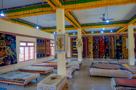 POKHARA, NEPAL - OCTOBER 06 2017: Unidentified grpup of women enjoying the asorted collection of colorful typical traditional handmade fabrics inside of a market, acomodated over a wooden structures inside of a store, in Kathmandu Nepalのeditorial素材