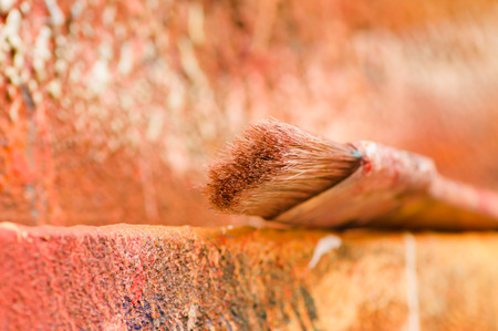 Close up of paint brushes over a color palette in a blurred backgroundの写真素材