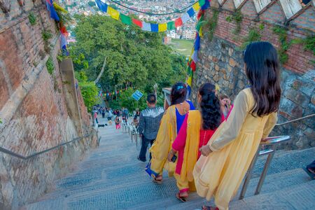 KATHMANDU, NEPAL OCTOBER 15, 2017: Unidentified people walking dowstairs to Swayambhu, from ancient religious architecture Kathmandu city. It is also known as Monkey Templeのeditorial素材