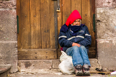 QUITO, ECUADOR NOVEMBER, 28, 2017: Unidentified homeless man in the sidewalk at historical center of old town Quito in northern Ecuadorのeditorial素材