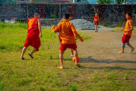 POKHARA, NEPAL - OCTOBER 06 2017: Unidentified Buddhist monk teenager playing soccer at the Sakya Tangyud monastery in the Spiti valley in Pokhara, Nepalのeditorial素材