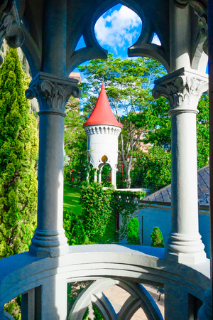 Beautiful outdoor view of the garden with a gorgeous view of the dome of the gothic medieval Castle Museum behind in Medellin, Colombia, South Americaの写真素材