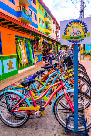 GUATAPE, COLOMBIA - OCTOBER 19, 2017: Close up of bikes parked in a row in a beautiful colorful streets and decorated houses of Guatape city near Medellin, Antioquia, Colombiaのeditorial素材