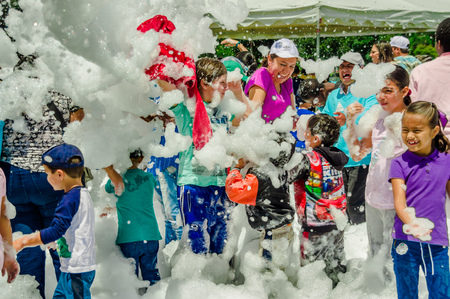 QUITO, ECUADOR- NOVEMBER, 28, 2017: Group of children having fun and dancing at a foam party at Quito festivalのeditorial素材