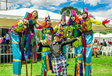 QUITO, ECUADOR- NOVEMBER, 28, 2017: Close up of unidentified people wearing a clown costume, having fun and dancing at a foam party at Quito festivalのeditorial素材