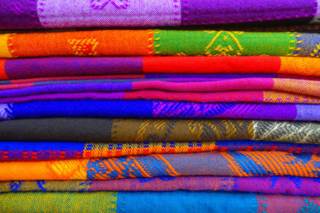 Close up of colorful Mexican blankets for sale at market, Latin America, fabric background