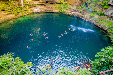 CHICHEN ITZA, MEXICO - NOVEMBER 12, 2017: Beautiful Ik-Kil Cenote pond with many people swimming, near Chichen Itza in Mexicoのeditorial素材