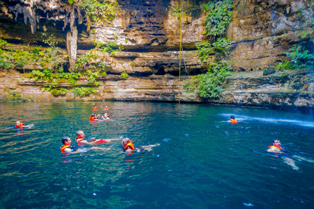 CHICHEN ITZA, MEXICO - NOVEMBER 12, 2017: Beautiful Ik-Kil Cenote pond with many people swimming, near Chichen Itza in Mexicoのeditorial素材