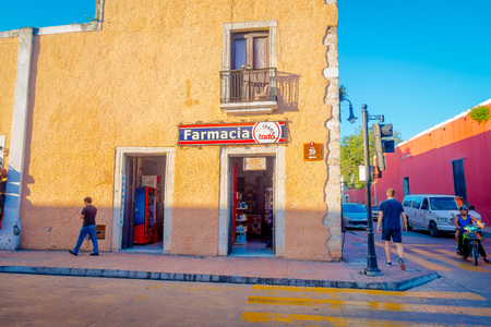 VALLADOLID, MEXICO - NOVEMBER 12, 2017: Unidentified people walking at outdoors of a colorful buildings in a Mexican street. Valladolid city center in Mexicoのeditorial素材