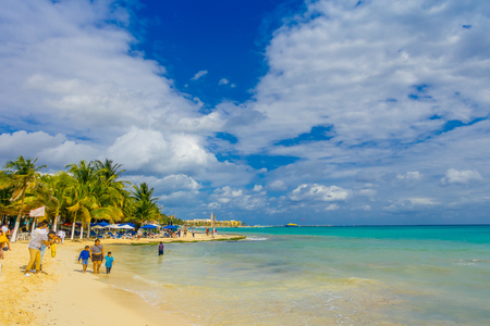 Playa del Carmen, Mexico - January 10, 2018: Unidentified woman with her children walking in the beach in Playa del Carmen and enjoying the beautiful viewのeditorial素材
