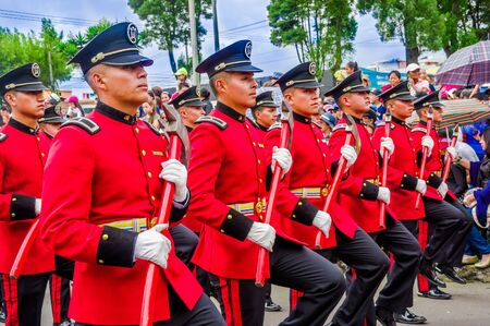 Quito, Ecuador - January 31, 2018: Outdoor view of unidentified group of firefighters team wearing a red equipment, marching in the streets during a parade in Quitoのeditorial素材