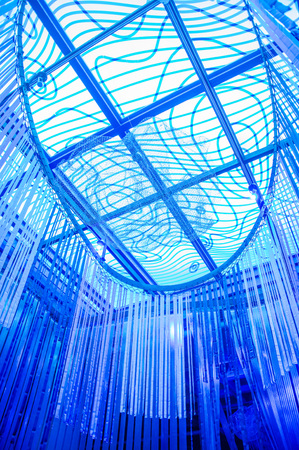 QUITO, ECUADOR, FEBRUARY 02, 2018: Indoor view of some meatllic structures and many piece of paper hanging from the rooftop inside of a water exposition of marine life in Yuaku water museum located in the city of Quito, with blue lightsのeditorial素材