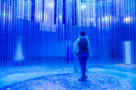 QUITO, ECUADOR, FEBRUARY 02, 2018: Indoor view of blurred people walking inside of a water exposition of marine life in Yuaku water museum located in the city of Quito, with blue lightsのeditorial素材