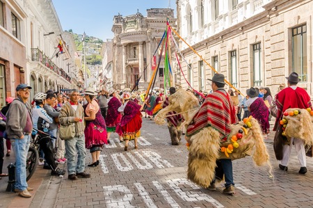 Quito, Ecuador - January 11, 2018: Outdoor view of unidentified people wearing beautiful dresses and straw hats, dancing in the streets during a parade in Quito, Ecuadorのeditorial素材