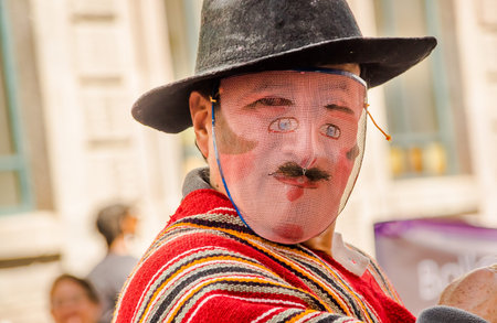 QUITO, ECUADOR - JANUARY 11, 2018: Portrait of unidentified people wearing a hat and mask, and...