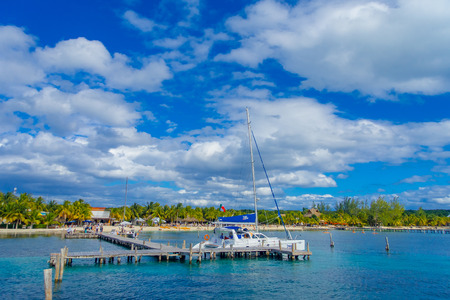 CANCUN, MEXICO - JANUARY 10, 2018: Outdoor view of unidentified people sailing in a yatcg Outdoor view of huge boat of color blue and yellow sailing in the waters close tothe Isla Mujeresのeditorial素材