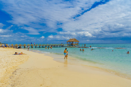 Playa del Carmen, Mexico - January 10, 2018: Unidentified people on the beach in Playa del Carmen at sunset. The city boasts a wide array of tourist activities due to its geographical location in the Riviera Mayaのeditorial素材