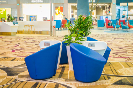 SINGAPORE, SINGAPORE - JANUARY 30, 2018: Indoor view of waiting lounge area with a blue sofa inside of Changi international airportのeditorial素材