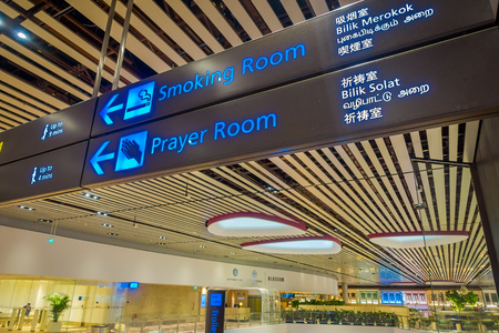 SINGAPORE, SINGAPORE - JANUARY 30, 2018: Close up of informative sign of smoking area and praying area at the interior of Changi Airportのeditorial素材
