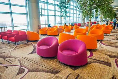 SINGAPORE, SINGAPORE - JANUARY 30, 2018: Indoor view of waiting lounge area with some colorful sofas inside of Changi international airportのeditorial素材