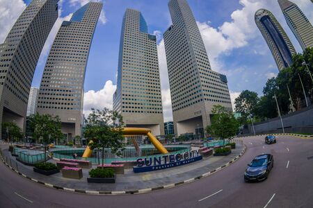 SINGAPORE, SINGAPORE - JANUARY 30. 2018: Beautiful outdoor view of fountain wealth with a public residential condominium building complex and downtown skylines at Kallang neighborhood in Singapore, fish eye effectのeditorial素材
