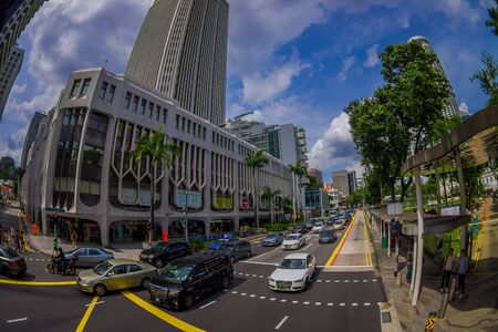 SINGAPORE, SINGAPORE - JANUARY 30. 2018: Above outdoor view of public residential condominium building complex and downtown at Kallang neighborhood with some cars in the streets and people walking in the sidewalk in Singapore, fish eye effectのeditorial素材