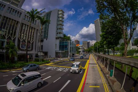 SINGAPORE, SINGAPORE - JANUARY 30. 2018: Above outdoor view of public residential condominium building complex and downtown at Kallang neighborhood with some cars in the streets and people walking in the sidewalk in Singapore, fish eye effectのeditorial素材