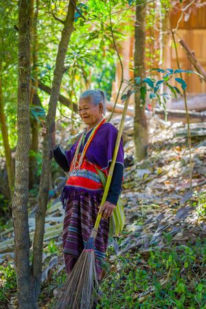 CHIANG RAI, THAILAND - FEBRUARY 01, 2018: Outdoor view of unidentified old woman walking in tropical rainforest in Chiang Mai Province, Thailandのeditorial素材