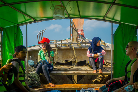 AO NANG, THAILAND - MARCH 05, 2018: Outdoor view of unidentified people inside of fishing thai boats at the shore of Po-da island, Krabi Province, Andaman Sea, South of Thailandのeditorial素材