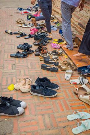 AYUTTHAYA, THAILAND, FEBRUARY, 08, 2018: Close up of outdoor view of many assorted shoes in the ground during a ceremony and praying time close to Wat Mahathat. Ayutthaya historical parkのeditorial素材