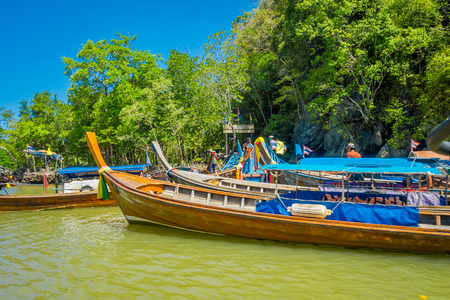 AO NANG, THAILAND - FEBRUARY 19, 2018: Outdoor view of long tail fishing boats in the riverside close to metallic structure in the pier located in the river at Krabi Province, South of Thailandのeditorial素材