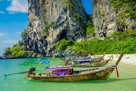 PHRA NANG, THAILAND - FEBRUARY 09, 2018: Beautiful outdoor view of long tail boats in a row in the shore of Phra nang island in a gorgeous sunny day and turquoise waterのeditorial素材
