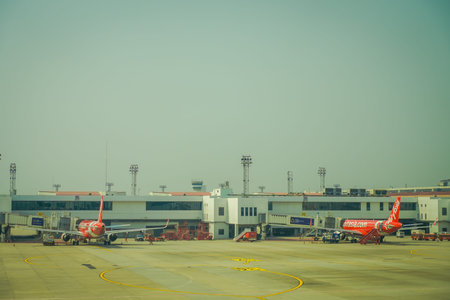 BANGKOK, THAILAND - FEBRUARY 09, 2018: Outdoor view of commercial aircraft, airasia with a tower...