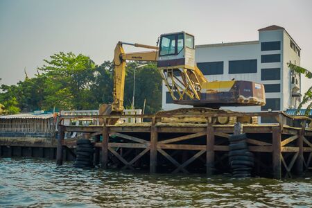 BANGKOK, THAILAND - FEBRUARY 09, 2018: Outdoor view of heavy machinary at riverside with neumatics hanging, at yai canal or Khlong Bang Luang Tourist Attraction in Thailandのeditorial素材