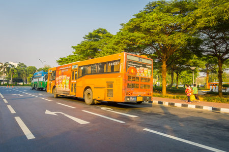 BANGKOK, THAILAND, FEBRUARY 08, 2018: Outdoor view of some public transport, yellow bus in a road of...
