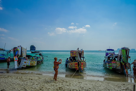 PHRA NANG, THAILAND - FEBRUARY 09, 2018: Beautiful outdoor view of unidentified people taking pictures to a long tail boat food market on Phra nang island in a gorgeous sunny day and turquoise waterのeditorial素材