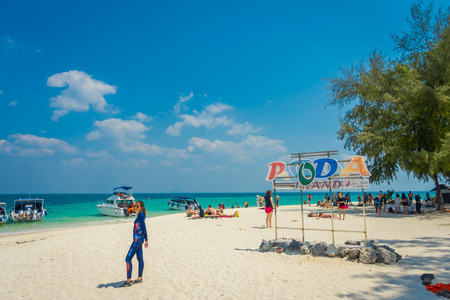 PODA, THAILAND - FEBRUARY 09, 2018: Outdoor view of unidentified people posing for a pictures in front of informative sign over the white sand on Poda island in a gorgeous sunny dayのeditorial素材