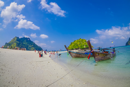 TUP, THAILAND - FEBRUARY 09, 2018: Beautiful outdoor view of unidentified people in the beach close to a long tail boats in a shore on Tup island in a gorgeous sunny day and turquoise waterのeditorial素材