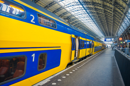 AMSTERDAM, NETHERLANDS, MARCH, 10 2018: Interior view ofAmsterdam Schiphol train station, passengers at the station. Historical and big train stationのeditorial素材