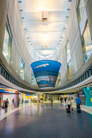 HOUSTON, USA- MARCH 10, 2018: Indoor view of unidentified people walking inside of Houston Intercontinental Airport, Houston, TX, USA - passengers walking with lugagge in airportのeditorial素材