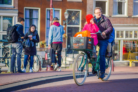 AMSTERDAM, NETHERLANDS, MARCH, 10 2018: Unidentified people riding bicycles in historical part in Amsterdamのeditorial素材